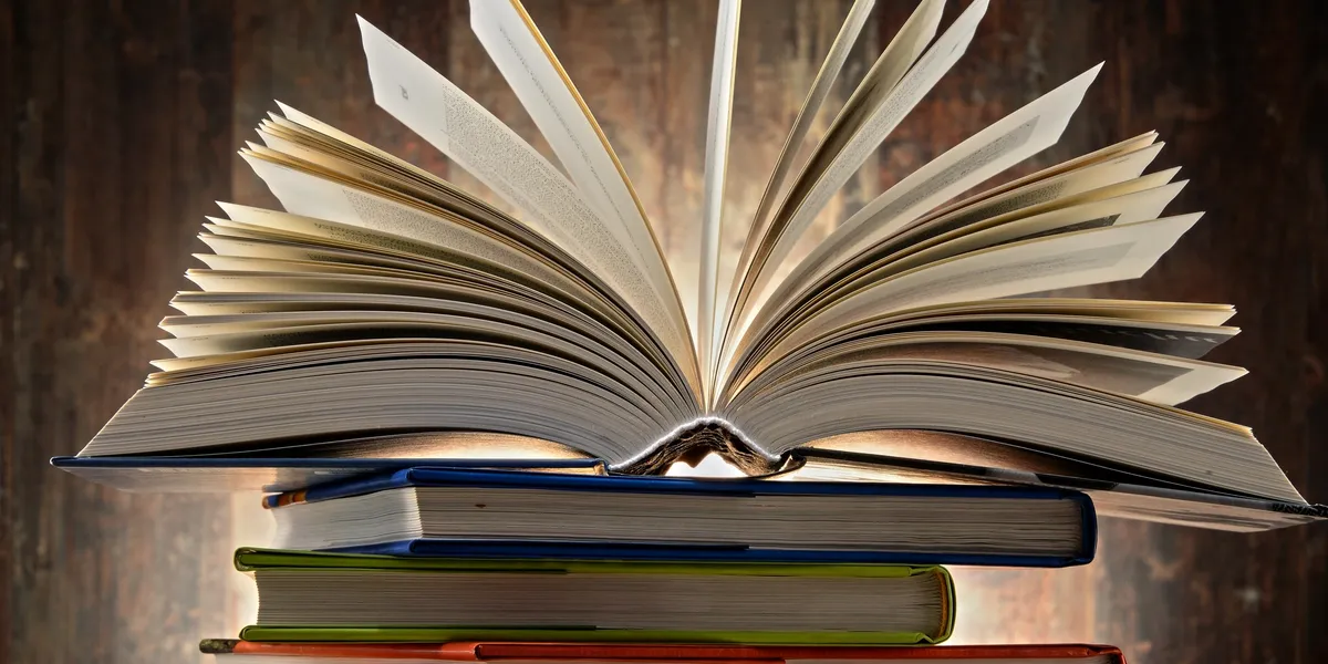A close up of an open book with the pages bent.