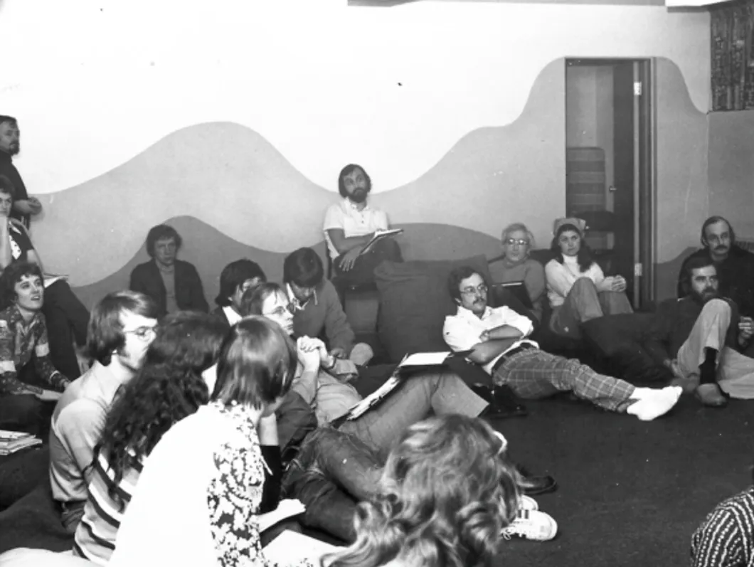 A group of people sitting on top of couches.