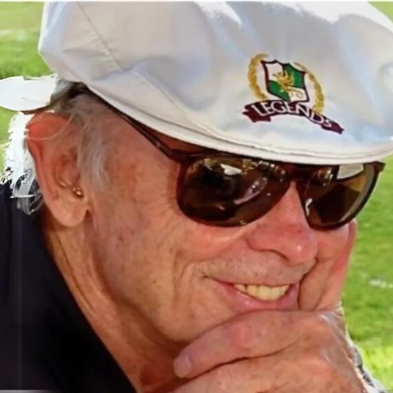 A man wearing sunglasses and a white hat.